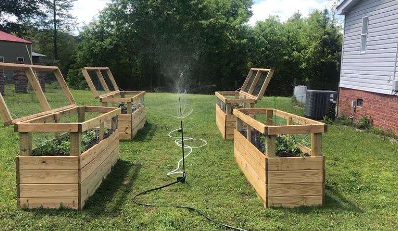 Edible landscape design featuring raised garden beds with herbs, fruits, and vegetables, crafted by Front Yard Forest in Lexington, SC